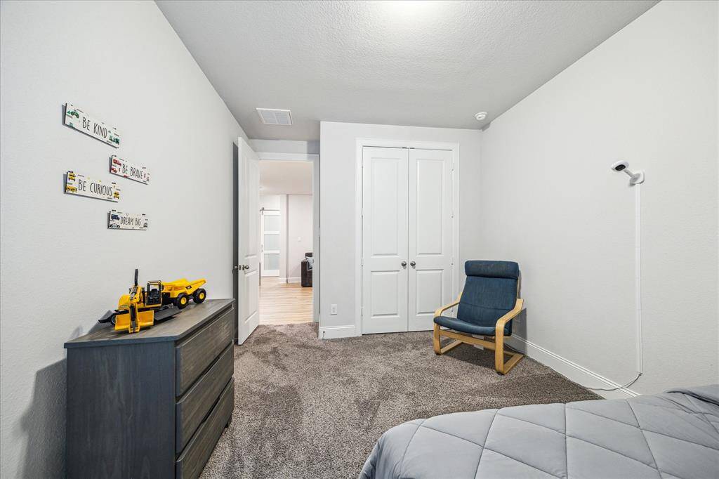 Matching secondary bedroom to the imagination room, closets with hanging space and storage cubby space, blackout shades on windows.