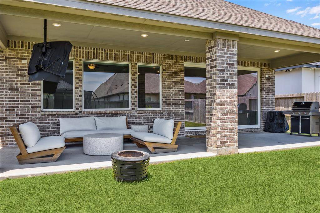 Additional view of the extended patio the runs the length of interior dining and living spaces.  Stacked slider makes moving between the spaces safe and easy.