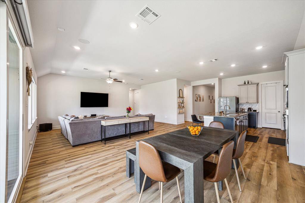 The open plan living, dining, kitchen areas are bathed in natural light and the spaces flow seamlessly from one to another for easy day-to-day life activities or larger scale entertaining. It is all a breeze. Upgrades include 8ft. doors and motorized, wifi-enabled window shades.