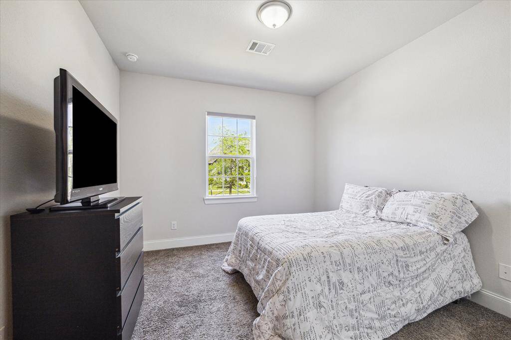 1st of the secondary bedrooms, located at the front of the home, has access to its own full bathroom and is across from the garage entry for use as a MIL suite or for older kids needing more privacy.