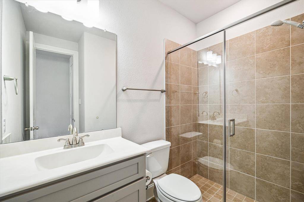 Secondary bathroom located at the front of the home, upgraded to a step-in shower for guests and/or family that may have mobility issues.
