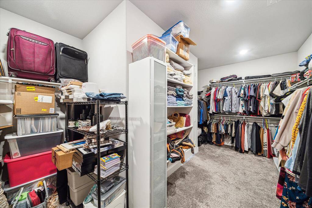 Primary closet has space for everything and then some.  Space to the left has long hanging space as well as open wall space to configure for any needs.