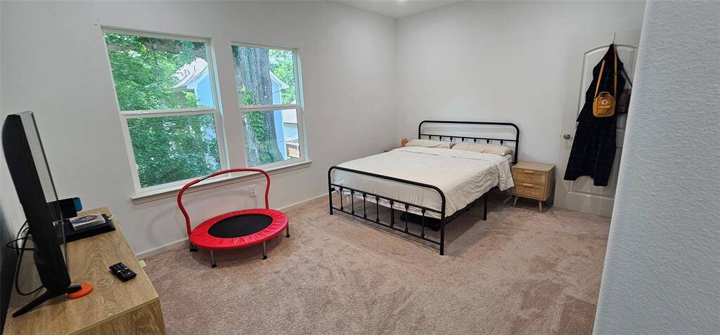 The owner's suite is bright and cozy. It has large windows with views of nature, bringing in so much natural light.