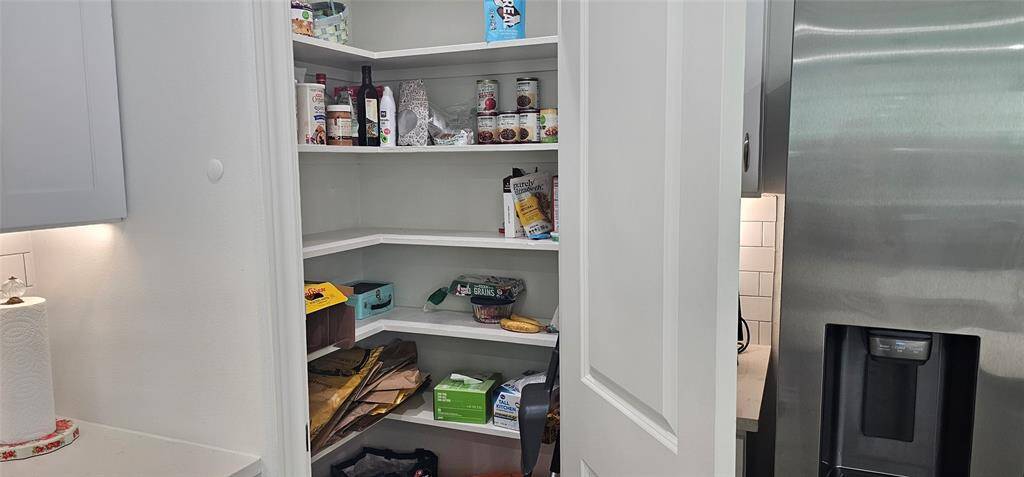 The kitchen has a walk-in pantry with ample space to stock all you need for meal preparation and more.