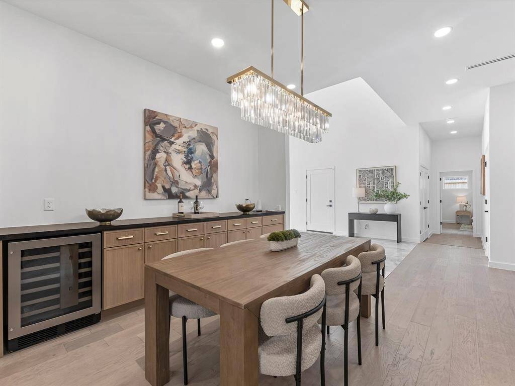 Dining room with storage cabinets and wine fridge.