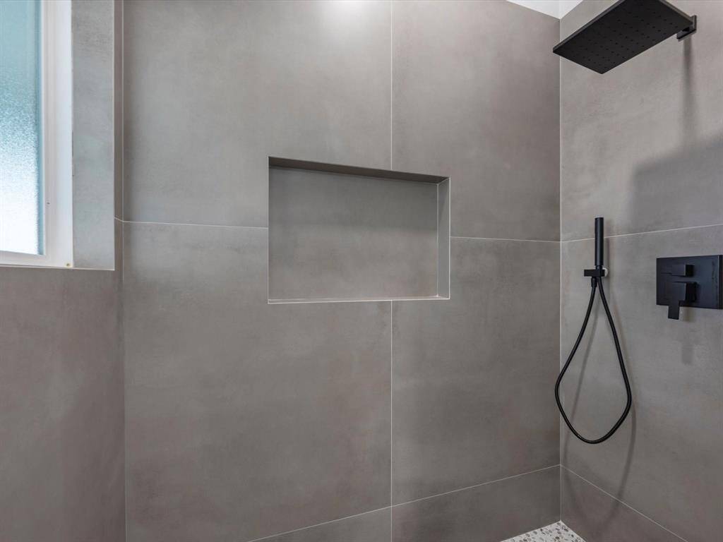 Primary shower with handheld shower.