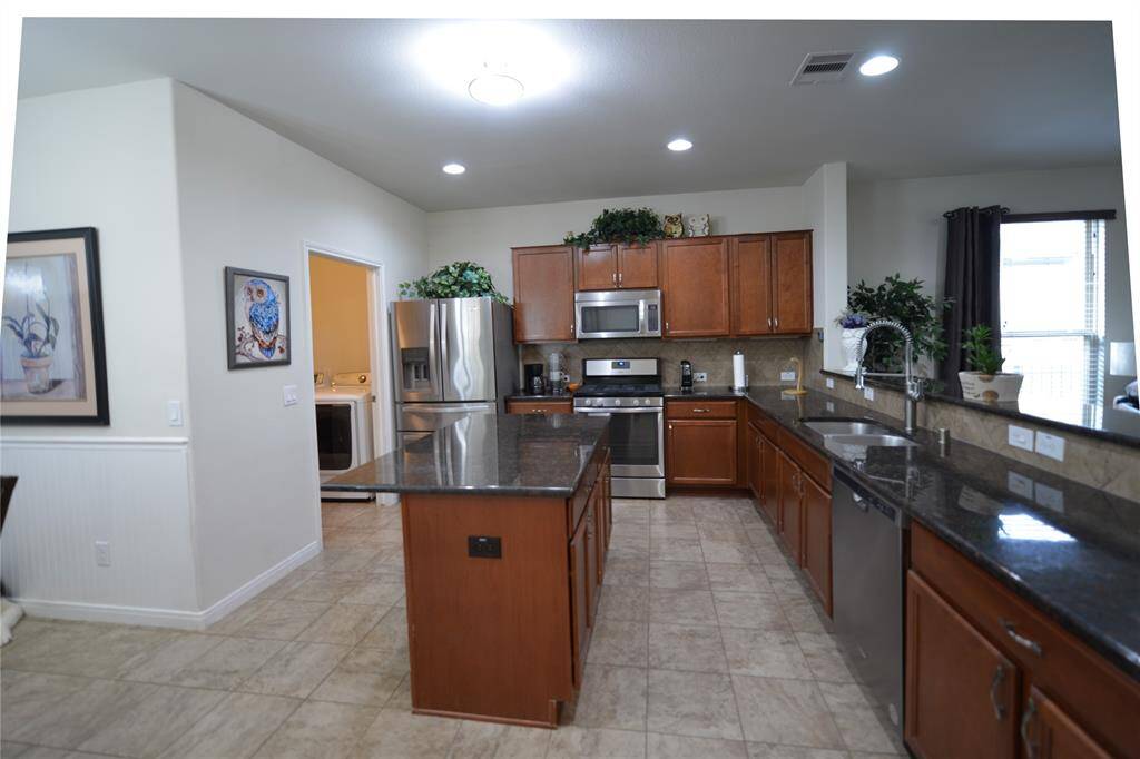 Refrigerator, washer, dryer included.