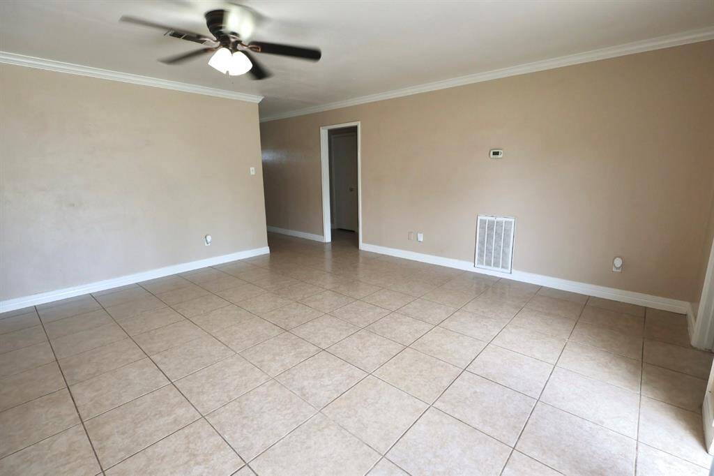 Inviting living area highlighted by sleek tile flooring, creating a fresh and open feel throughout the space