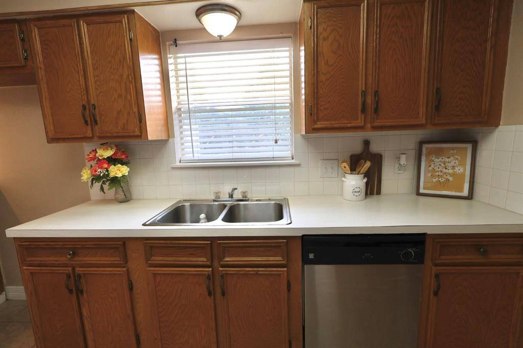Charming kitchen with a windowed sink area, creating a light-filled, cheerful atmosphere perfect for everyday living. New Dishwasher May 8, 2025
