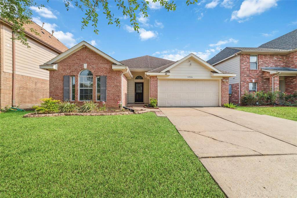 Beautiful one story home with arc top window detailing and double wide driveway