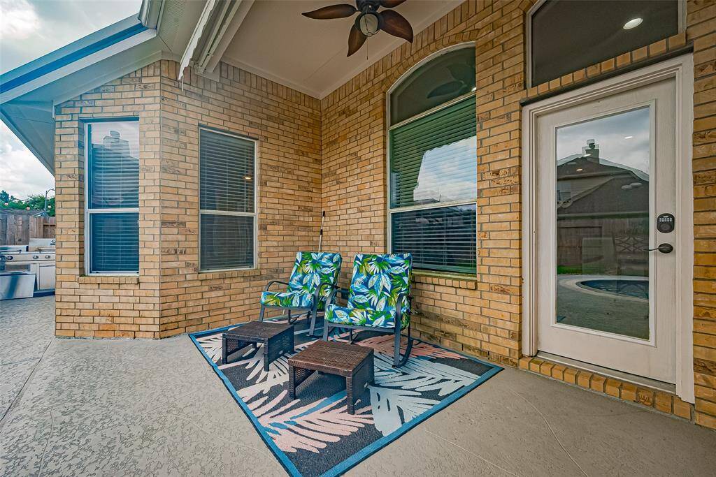 This photo highlights a cozy outdoor patio, perfect for grilling and entertaining. Enjoy the ideal outdoor living space with a relaxing view of the pool.