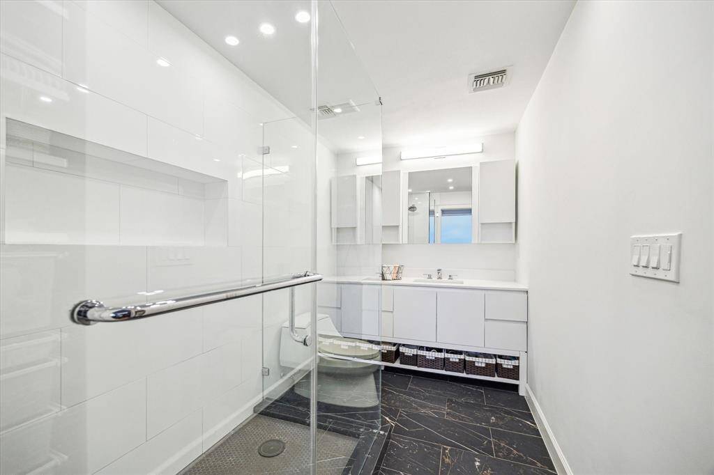 This exceptional primary bathroom was designed with a spa-inspired aesthetic, this space offers a perfect blend of luxury and functionality.