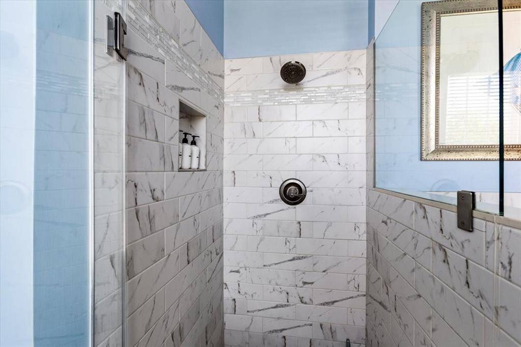En suite located at the rear of the home in 2nd Primary bedroom.
