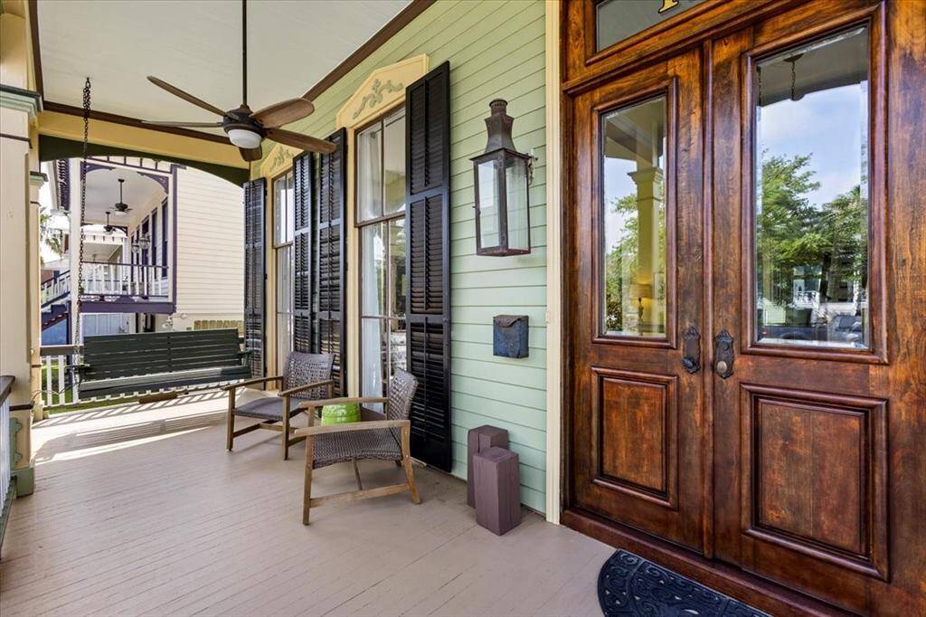 Gorgeous front porch with working gas lanterns, framing the front door.