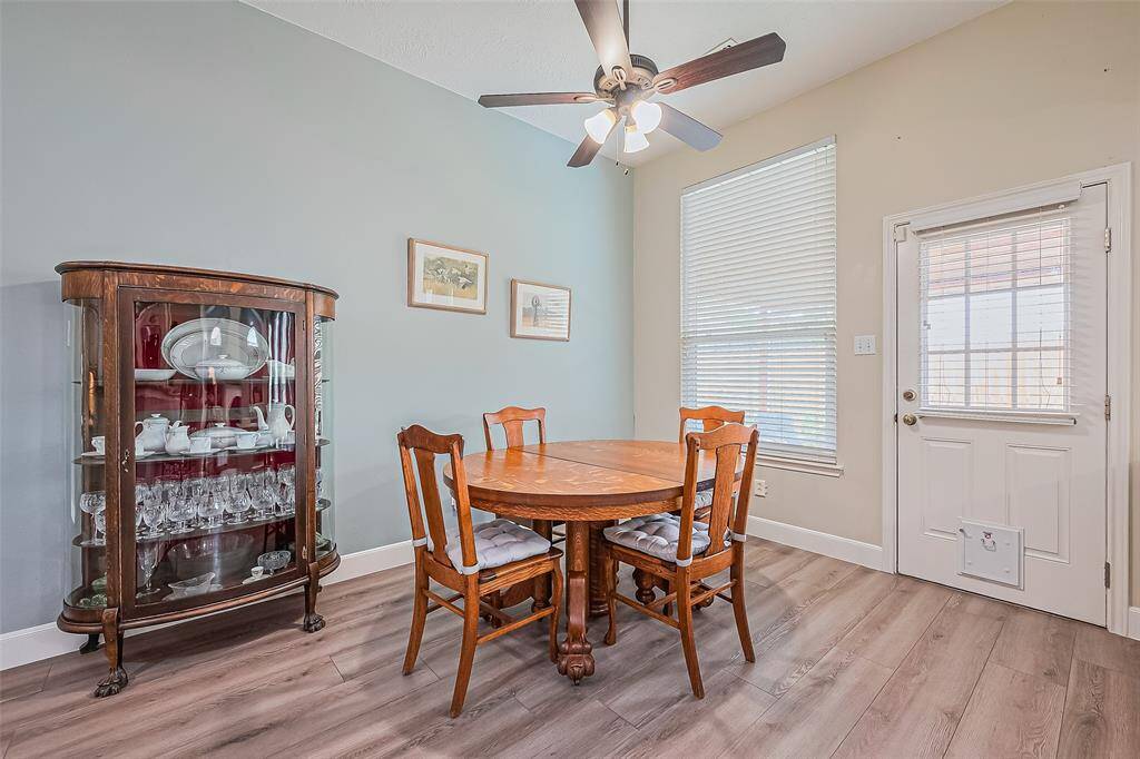 Cozy breakfast room featuring elegant updated floors and overlooking the backyard.