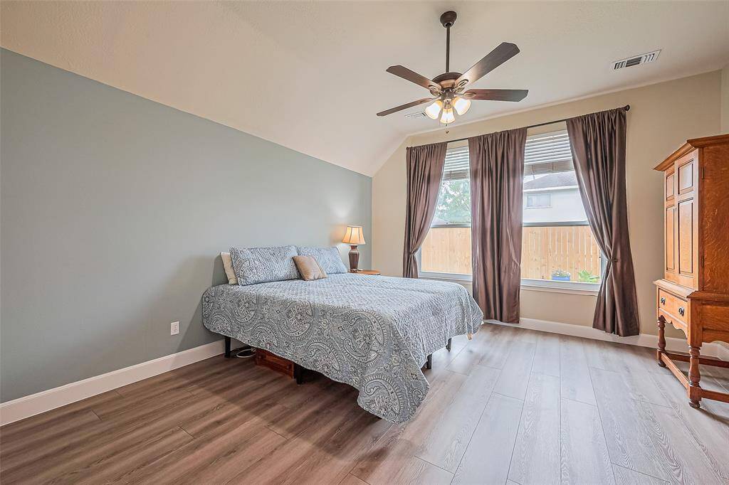 Luxurious primary bedroom with an elegant en suite bathroom.