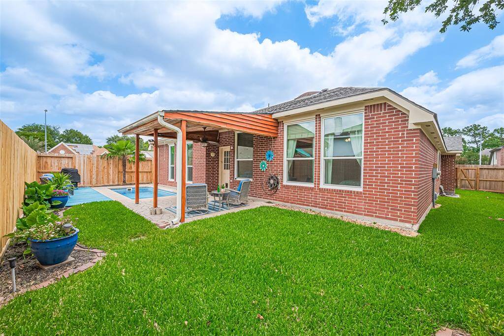 Charming brick exterior with a recently installed roof and fence for added privacy and visual appeal.
