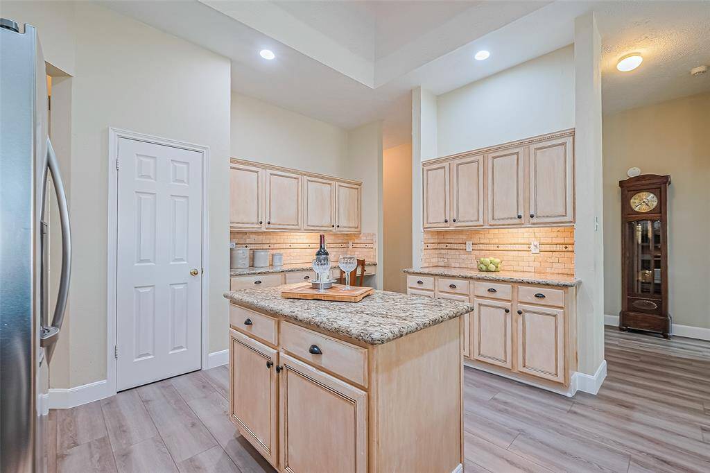 This stunning kitchen boasts ample counter and cabinet space.