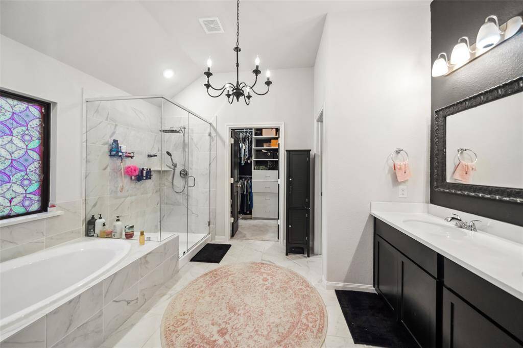 A soaker tub, separate shower, and custom built in closet are nice features.