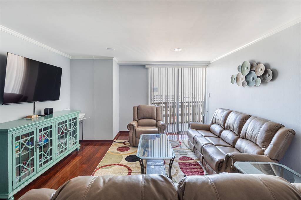 Living room with 5 recliners and tv, printer, view of downtown