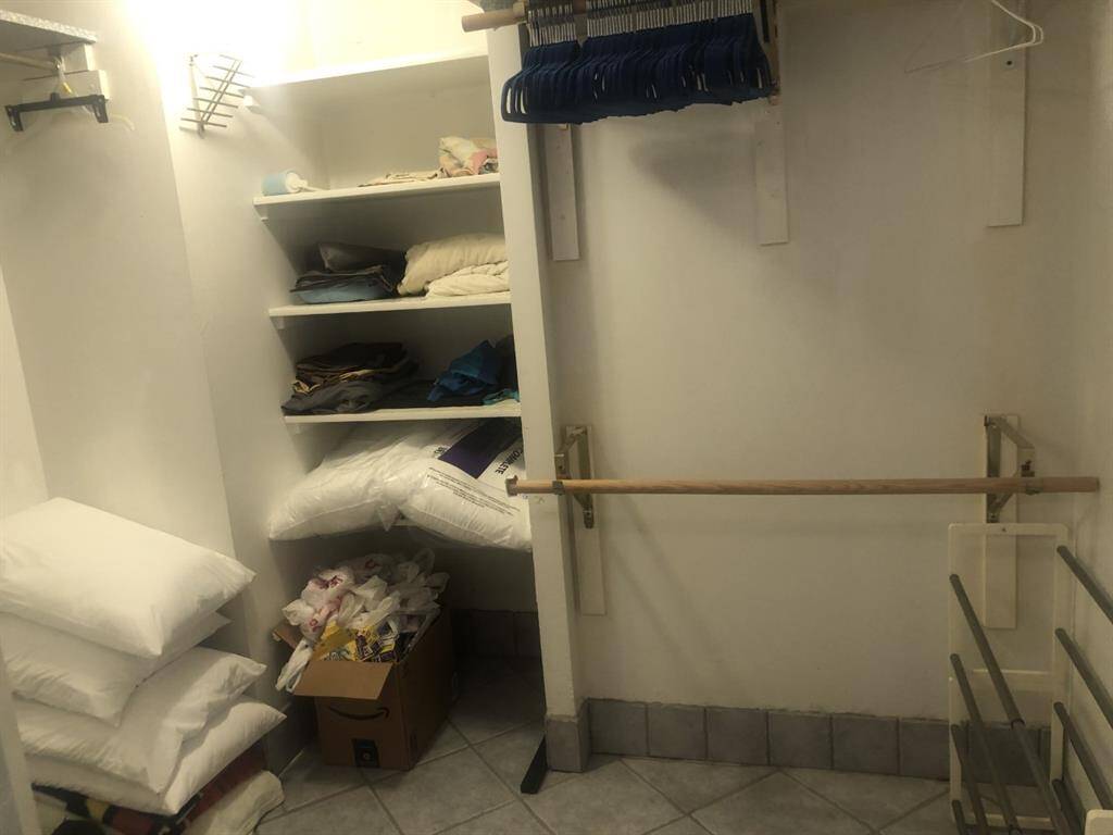 Queen walk in closet with extra bedding