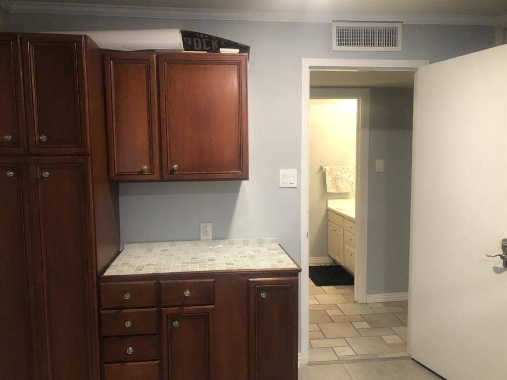Loft bedroom has built in cabinets and closet