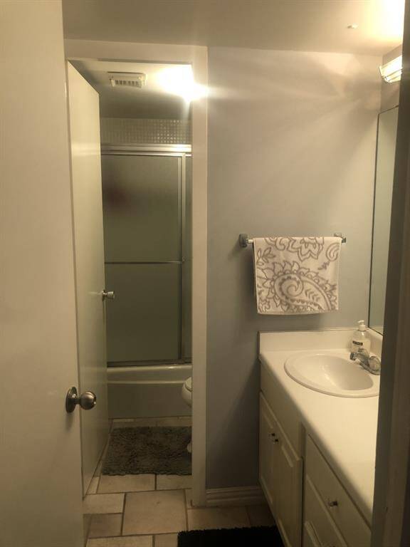 Private bathroom off hallway w/extra closet