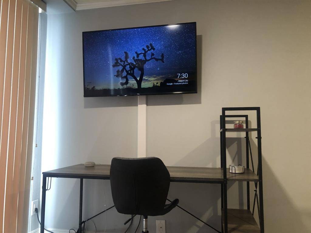 Smart tv and desk in loft bedroom