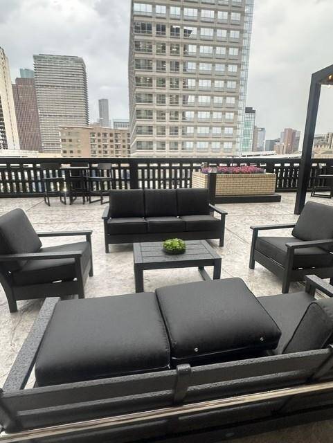 Outdoor sitting area with various tables and seating and outdoor kitchen and firepit and pool with spa.