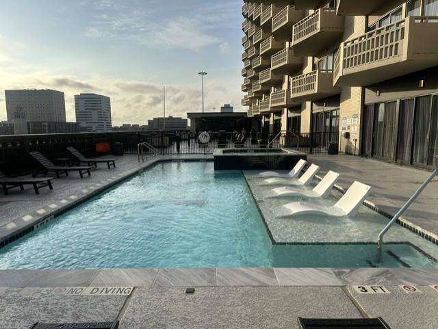 Pool goes into terrace area with firepit, seating, outdoor kitchen