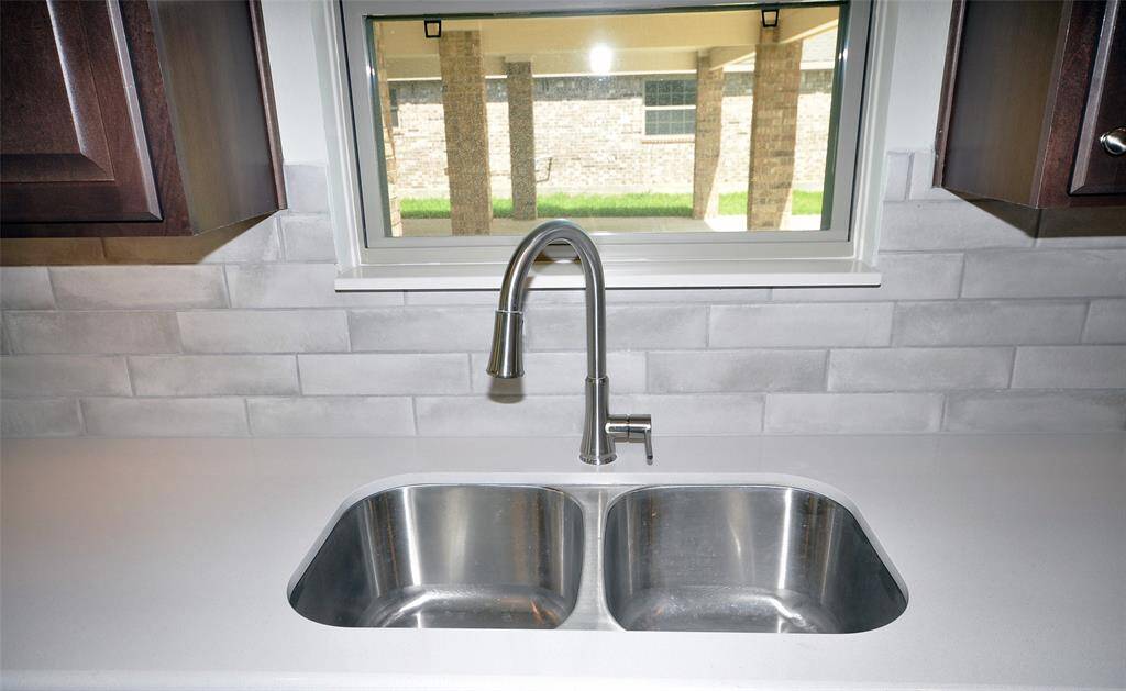 Undercounted stainless sink with a window overview.