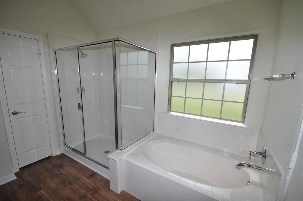 Separate tub and shower in the master bath.