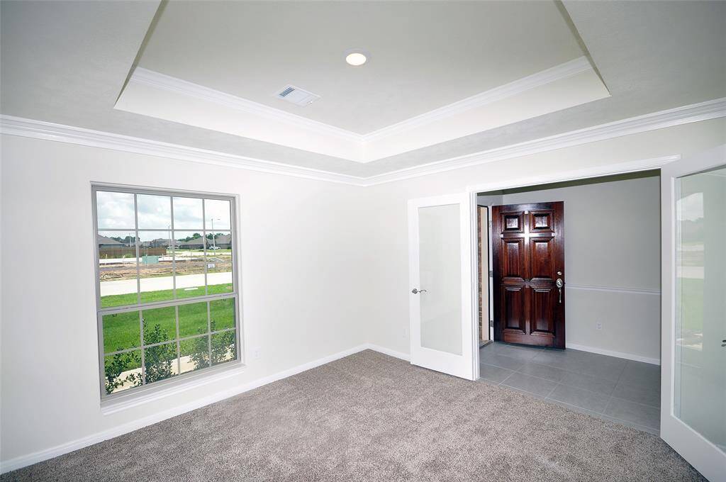 French Doors off the foyer into a formal dining room.