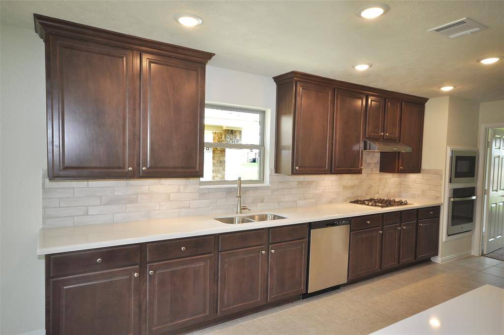 Wide expanse of Omegastone counters and beautiful Chestnut cabinetry.