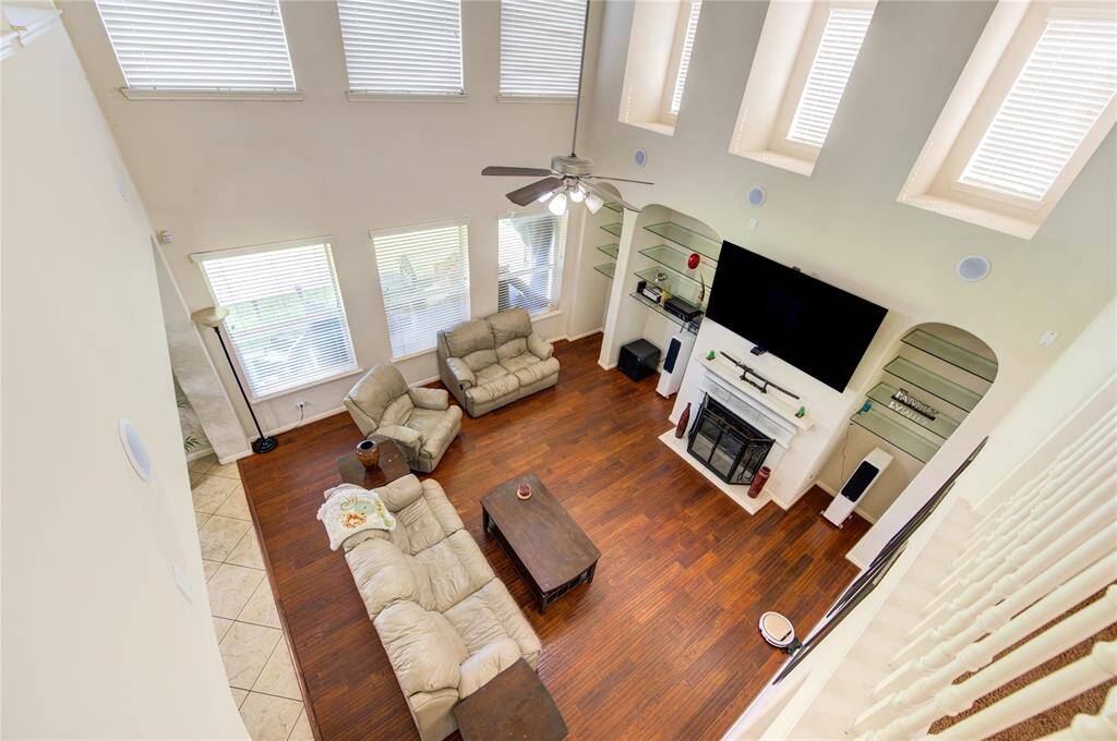Alternate living room angle highlighting ceiling height and design.