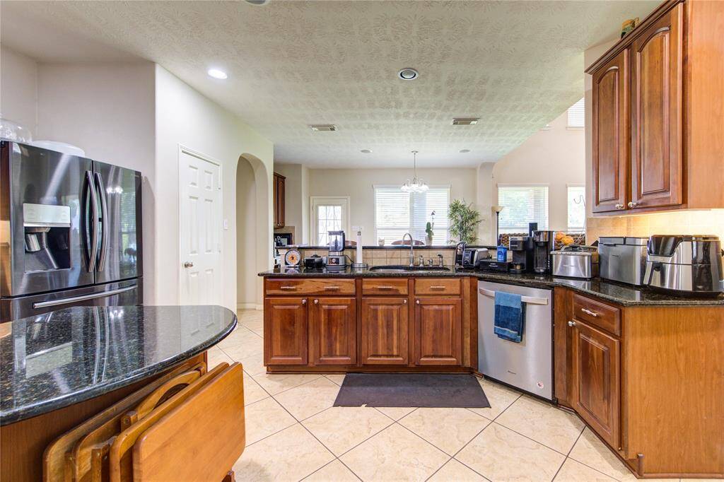 Another angle showcasing the wall oven, microwave, and gas cooktop.