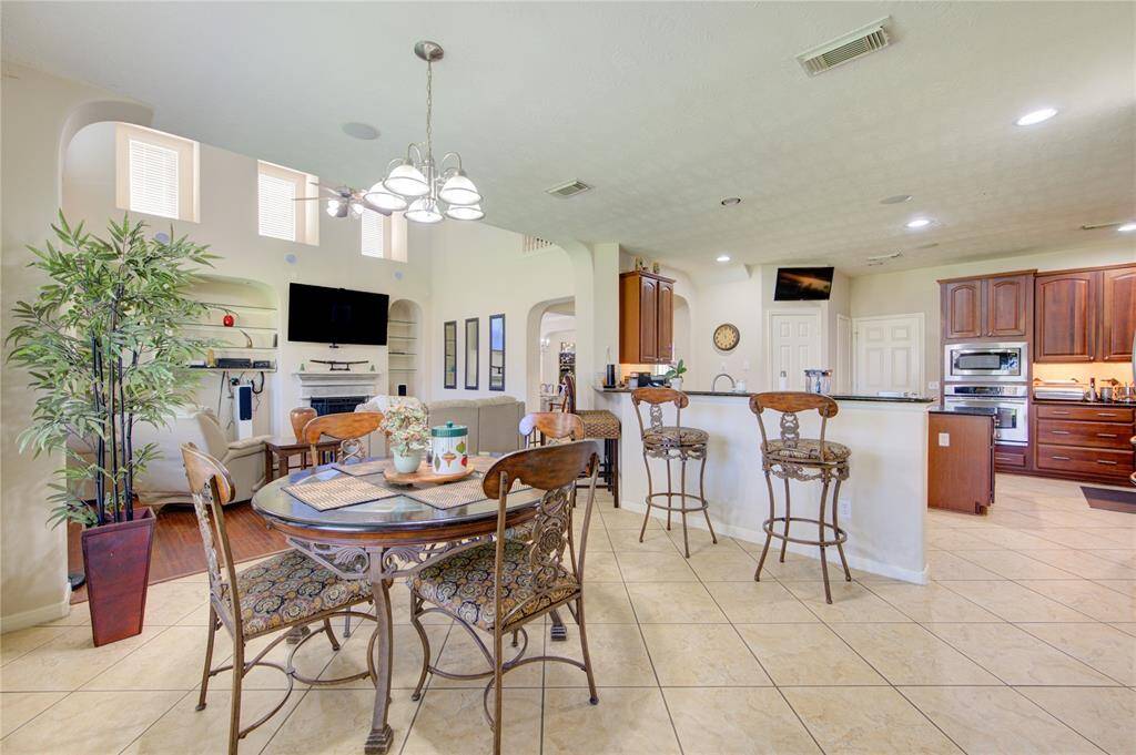 Bright breakfast area with island seating and open sightlines to the living space.