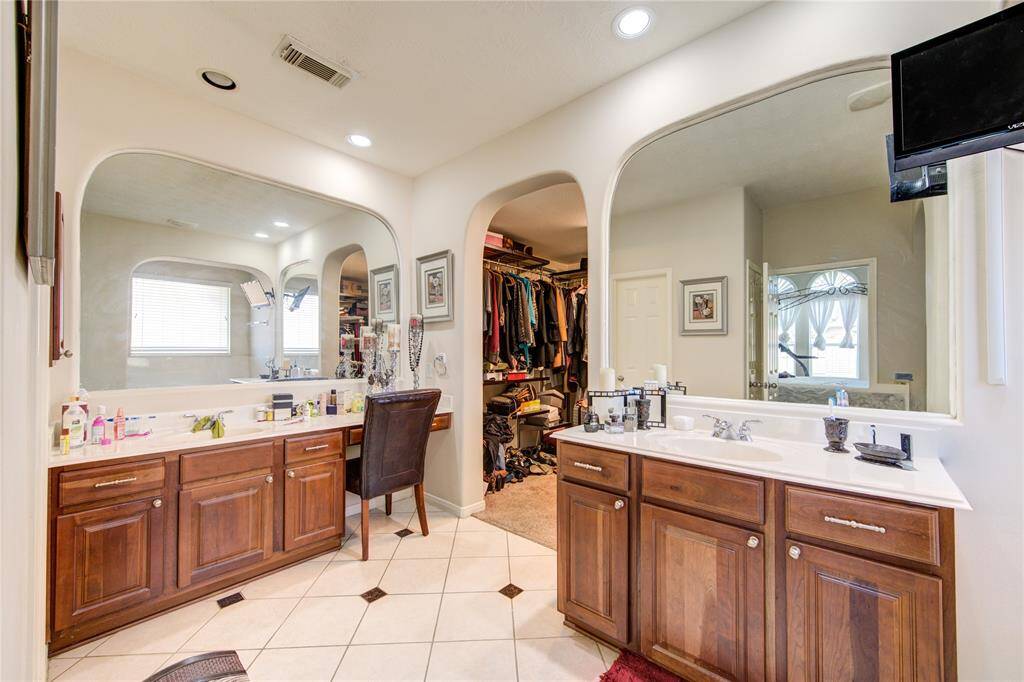 Vanity area in the primary bathroom with dual sinks and plenty of storage.