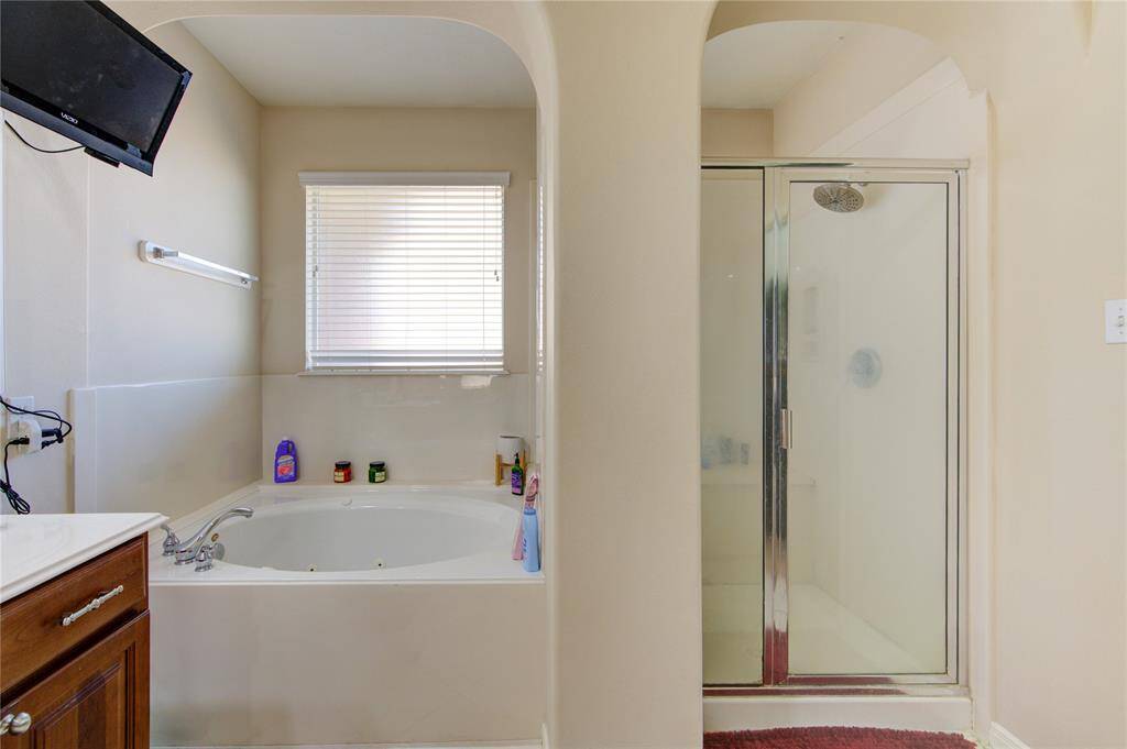 Soaking tub and separate walk-in shower in the primary bath.