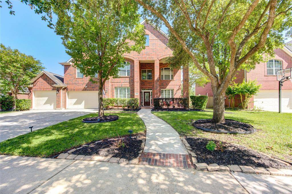 Stunning front exterior with spacious driveway and beautiful curb appeal.