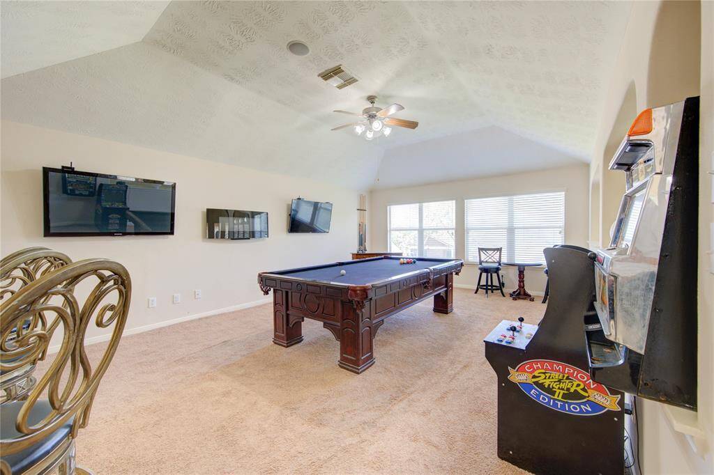 Expansive game room upstairs, perfect for entertaining or relaxing.