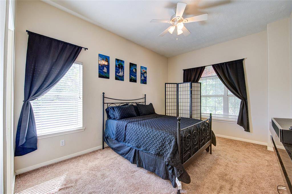Well-lit secondary bedroom featuring modern decor and ample natural light.
