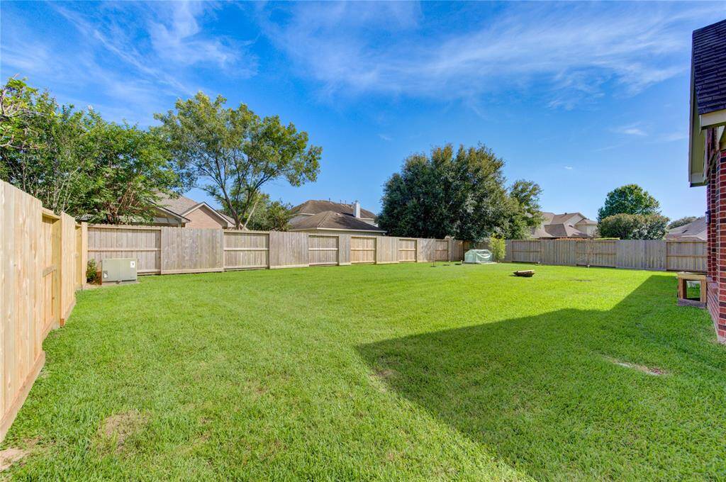 Huge backyard with plenty of room for a pool, garden, or entertaining.