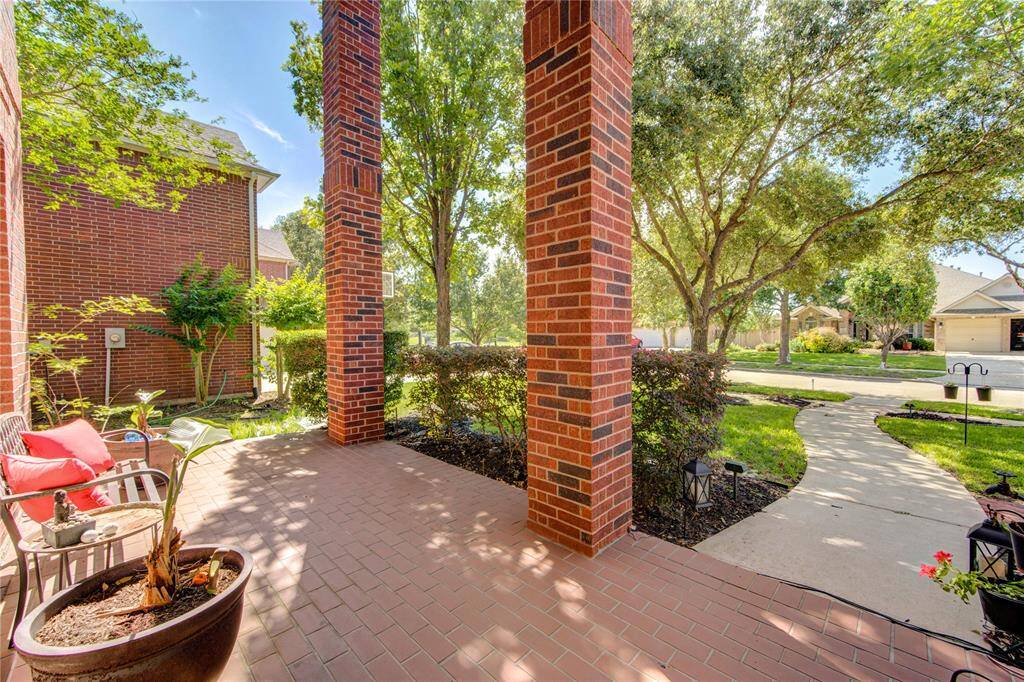 Covered Front Patio showcasing a beautiful yard