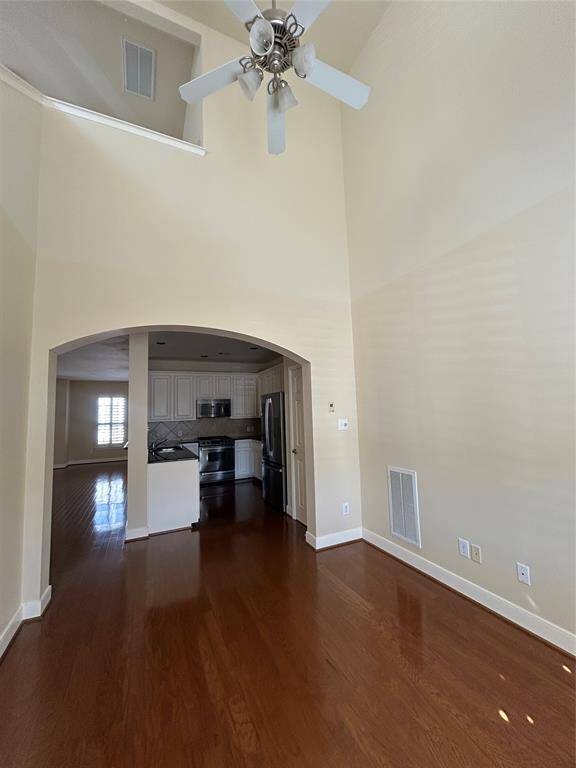 This spacious study features soaring ceilings and large shuttered windows that flood the room with natural light.