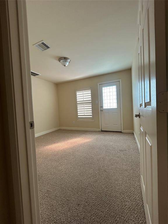 Versatile space ideal as a guest bedroom, media room, or home gym—complete with access to the outdoor patio and a full first-floor bathroom for added convenience.