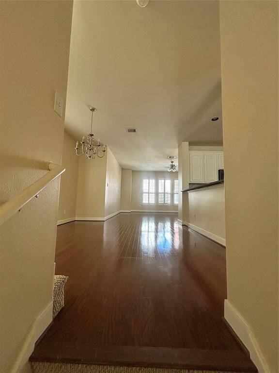 As you enter this spacious interior featuring hardwoods throughout, you'll find the formal dining room to the left and the kitchen with a stylish bar to the right, leading seamlessly into the main living area.