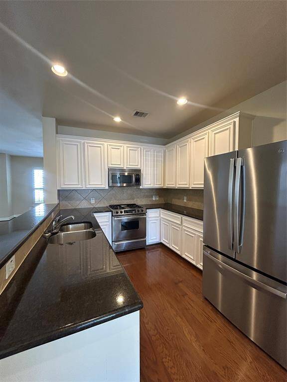 The kitchen boasts expansive counter space for effortless meal prep, complemented by easy access to sleek stainless steel appliances.