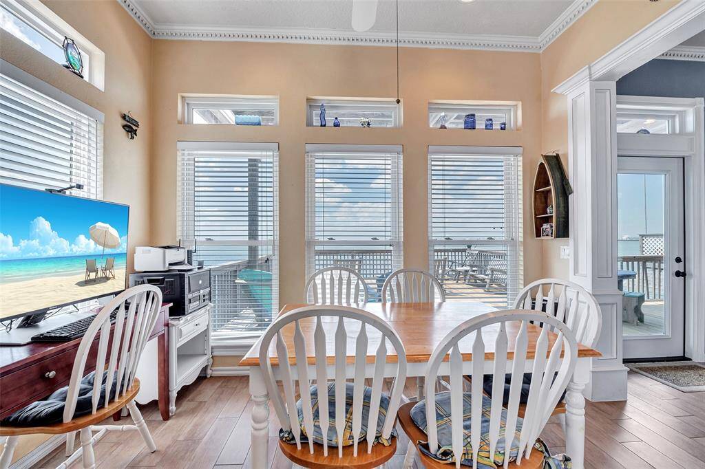 The Sunny Dining area blends seamlessly from kitchen to dining, framed by floor-to-ceiling windows that capture panoramic bay views.