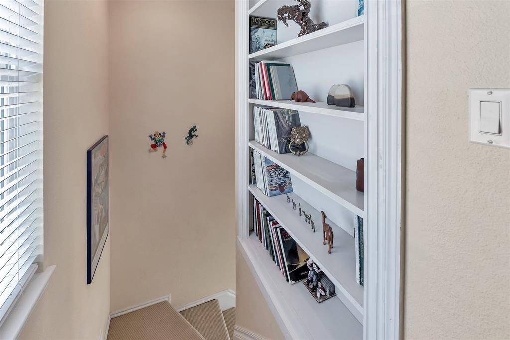 Tucked along the stairway landing, this custom built-in shelving adds character and function, perfect for displaying books, art, or collected keepsakes. A thoughtful touch that makes the space feel like home.